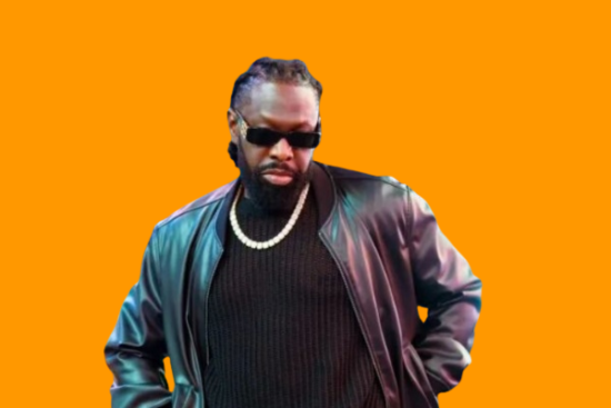 Timaya sparks reactions as he rocks bum shorts and knee-length boots.